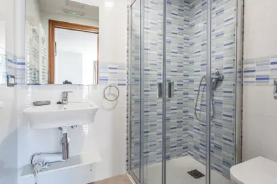 a bathroom with a sink and a shower at Pensión O Castelo in Palas de Rei