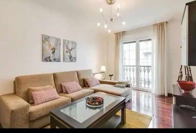 a living room with a couch and a table at Alojamiento A Tafona in Caldas de Reis