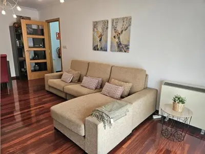 a living room with a couch and a table at Alojamiento A Tafona in Caldas de Reis