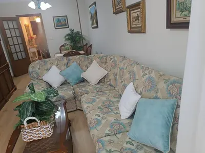a couch with pillows on it in a living room at Sobre el Puerto in Viveiro
