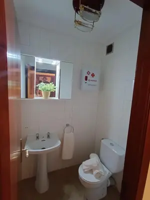 a bathroom with a sink and a toilet and a mirror at Sobre el Puerto in Viveiro