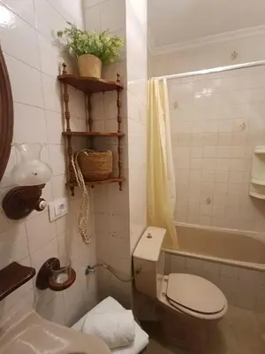 a bathroom with a toilet and a sink and a tub at Sobre el Puerto in Viveiro