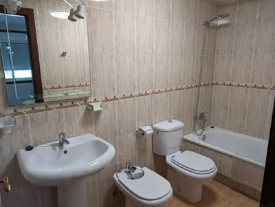 a bathroom with a sink and a toilet and a bath tub at Don Manuel Cuntis in Cuntis