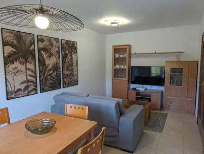 a living room with a blue couch and a table at Don Manuel Cuntis in Cuntis