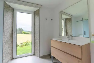 a bedroom with two beds and a desk and a window at Reverence Villas Carballal in Palas de Rei