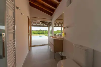 a room with two beds and a table and chairs at Reverence Villas Carballal in Palas de Rei