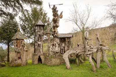 a statue of a wooden house in the grass at Casa Rural Lar de Sanxes in A Pontenova
