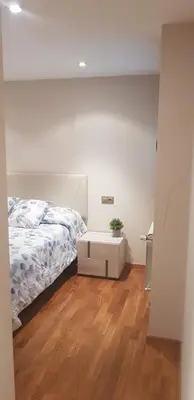 a bedroom with a bed and a wooden floor at Centro Viveiro in Viveiro