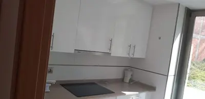 a kitchen with white cabinets and a counter top at Centro Viveiro in Viveiro