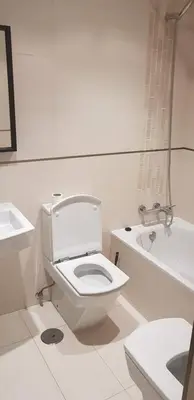 a white bathroom with a toilet and a bath tub at Centro Viveiro in Viveiro