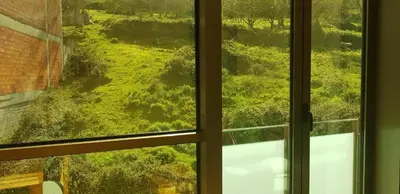 an open window with a view of a green field at Centro Viveiro in Viveiro