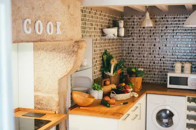 a kitchen with a counter top with a dishwasher at Apartamentos Aurelia Antica in Santiago de Compostela