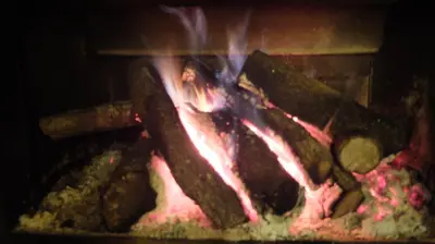 a fire is coming out of an oven at Hotel Rural La Casa del Peregrino in El Acebo de San Miguel