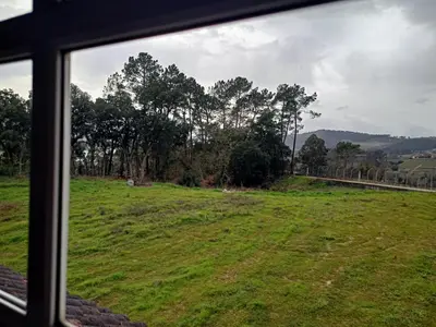 a view of a field from a window at CASA DO AVÒ in Castrelo de Miño