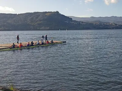 a group of people in a row boat on the water at CASA DO AVÒ in Castrelo de Miño