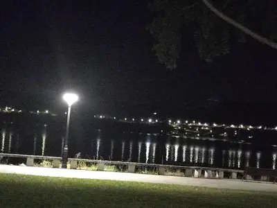 a street light next to a body of water at night at CASA DO AVÒ in Castrelo de Miño
