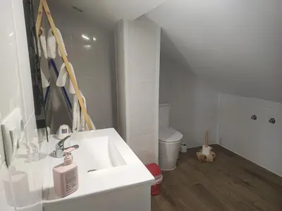 a white bathroom with a sink and a toilet at CASA DO AVÒ in Castrelo de Miño