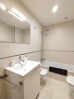 a white bathroom with a sink and a toilet at Viveiro Bahía in Viveiro