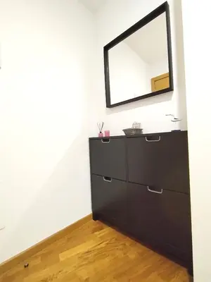 a black dresser with a mirror on a wall at Viveiro Bahía in Viveiro