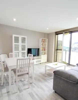 a living room with a table and chairs and a couch at Viveiro Bahía in Viveiro