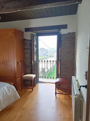 a bedroom with a bed and a large window at CASA DA RIBEIRA in Quiroga