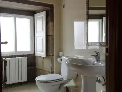 a bathroom with a white toilet and a sink at Hospedaje Ramos in Santiago de Compostela