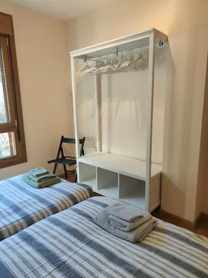 a bedroom with two beds and a bunk bed at Ventana al Paraíso del Oso - Somiedo. Window to Bear Paradise - Somiedo in Pola de Somiedo