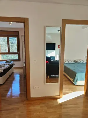 a mirror in a room with a bed and a bedroom at Ventana al Paraíso del Oso - Somiedo. Window to Bear Paradise - Somiedo in Pola de Somiedo