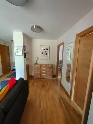 a living room with a couch and a dresser at Ventana al Paraíso del Oso - Somiedo. Window to Bear Paradise - Somiedo in Pola de Somiedo
