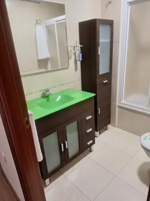 a bathroom with a green sink and a mirror at Jardines in O Barco de Valdeorras