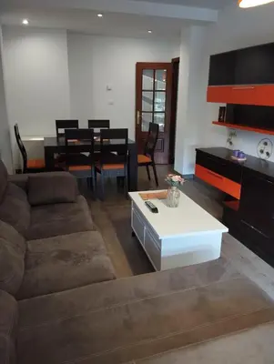 a living room with a couch and a table at Jardines in O Barco de Valdeorras