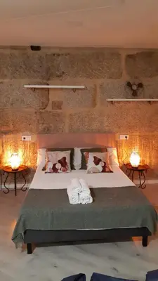 a bedroom with a bed with two towels on it at Apartamentos SARABIA LOFT in Ourense