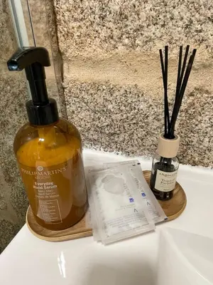 a bottle of soap sitting on top of a sink at Apartamentos SARABIA LOFT in Ourense