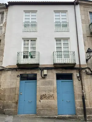 two blue doors on the side of a building at Apartamentos SARABIA LOFT in Ourense