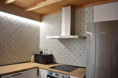 a kitchen with a stove and a refrigerator at Cabanas do Carpinteiro / Santiago de Compostela - Rías Baixas in Pontevedra