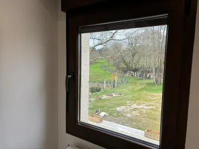 a window with a view of a green field at Cabanas do Carpinteiro / Santiago de Compostela - Rías Baixas in Pontevedra