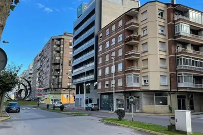 an empty street in a city with tall buildings at Piso Turístico Avda del Castillo in Ponferrada