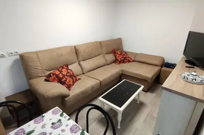 a living room with a couch and a table at Piso Turístico Avda del Castillo in Ponferrada