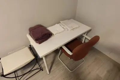 a small table and a chair in a room at Piso Turístico Avda del Castillo in Ponferrada