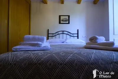 a bedroom with a bed with towels on it at O Lar de Mateo in Monforte de Lemos