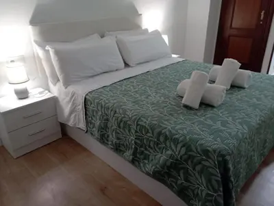 a bedroom with a bed with two pillows on it at Pardiñas 36 in Santiago de Compostela