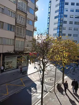 a group of people walking in a city with buildings at Pardiñas 36 in Santiago de Compostela