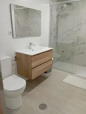 a bathroom with a toilet and a sink and a shower at Pardiñas 36 in Santiago de Compostela