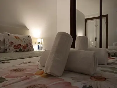 a bedroom with white towels on a bed at Pardiñas 36 in Santiago de Compostela