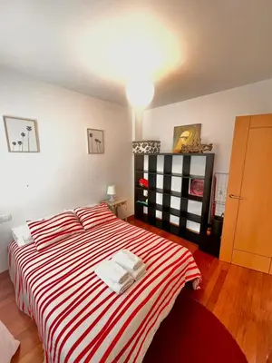 a living room with a couch and a table at Apartamento Luminoso y Acogedor in Lalín