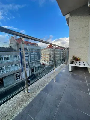 a living room with a large tv and a table at Apartamento Luminoso y Acogedor in Lalín