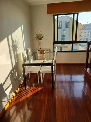 a dining room with a table and chairs and a window at Alojamiento entero cerca de Santiago de Compostela in A Coruña