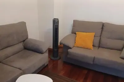 a living room with a couch and a lamp at Alojamiento entero cerca de Santiago de Compostela in A Coruña