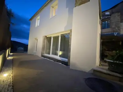 a white building with a window at night at dpCristal Centro Histórico in Sarria