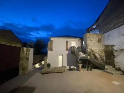 a white house with stairs in front of it at dpCristal Centro Histórico in Sarria